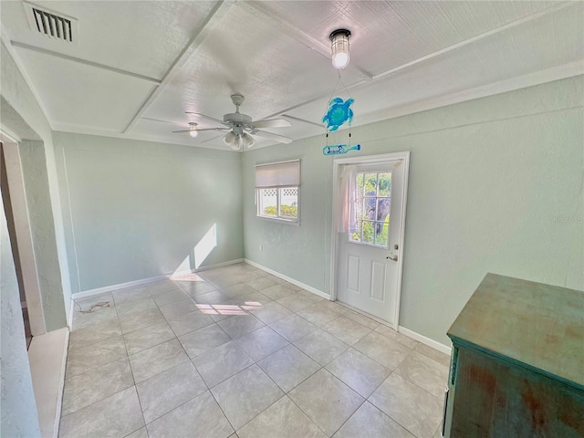 empty room featuring light tile patterned floors and ceiling fan