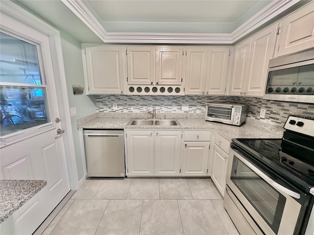 kitchen with stainless steel appliances, backsplash, white cabinets, and sink