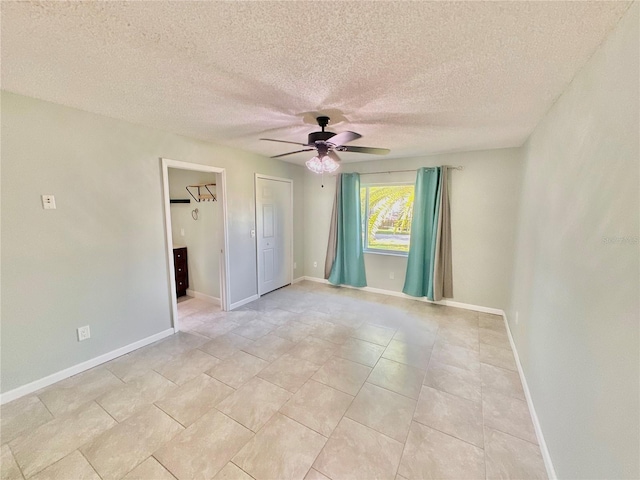 unfurnished room with a textured ceiling and ceiling fan