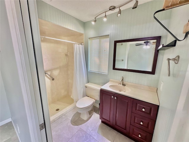 bathroom featuring ceiling fan, vanity, walk in shower, and toilet