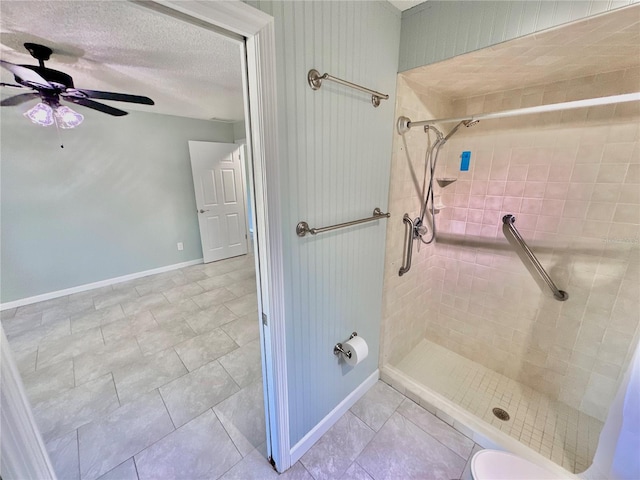 bathroom with ceiling fan, toilet, a tile shower, and tile patterned floors