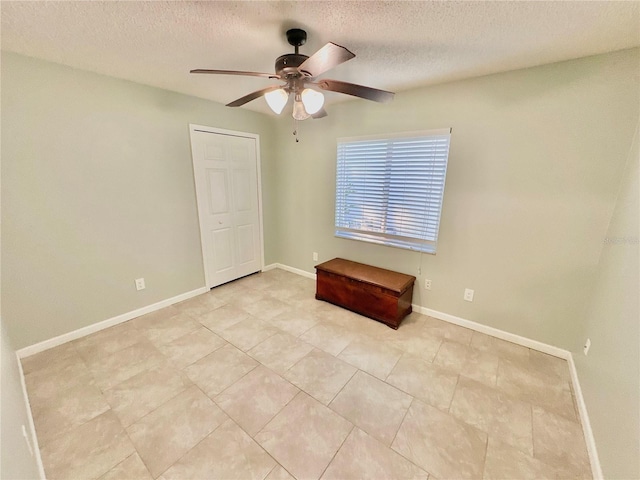 spare room featuring ceiling fan and a textured ceiling