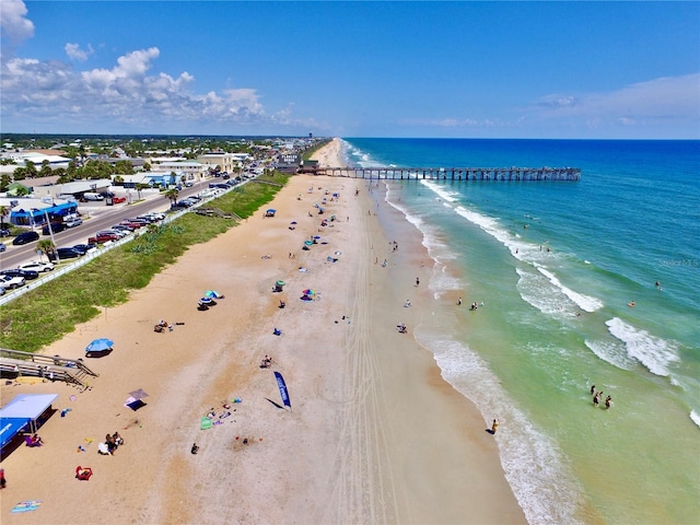 drone / aerial view featuring a beach view and a water view