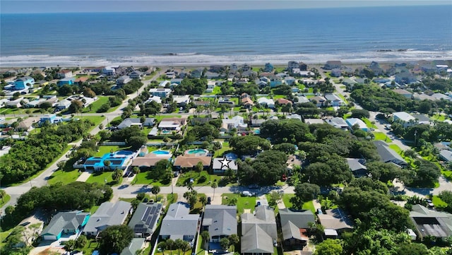 drone / aerial view with a water view and a beach view