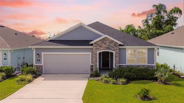 view of front of home featuring a garage and a yard