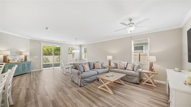 living room with crown molding, light hardwood / wood-style flooring, and ceiling fan with notable chandelier