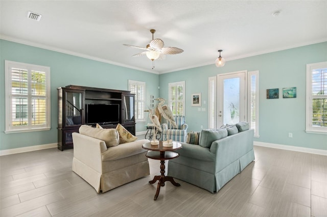 living room with ceiling fan and crown molding