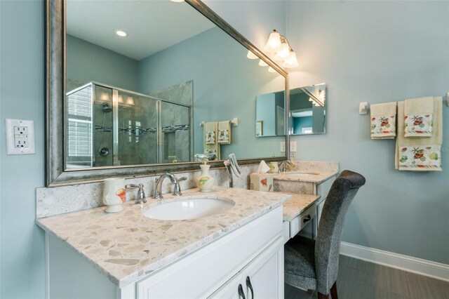 bathroom featuring vanity, a shower with door, and hardwood / wood-style flooring