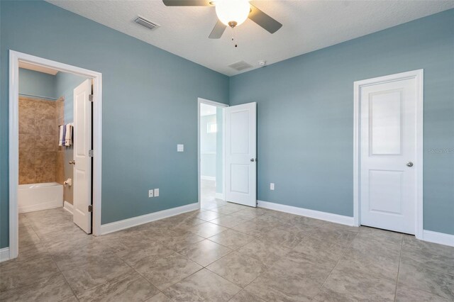 unfurnished bedroom featuring ceiling fan and ensuite bathroom