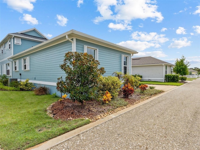 view of property exterior with a lawn