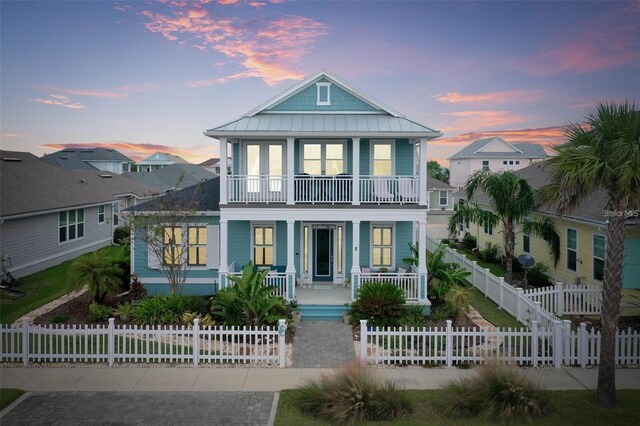 view of front of property featuring covered porch and a balcony