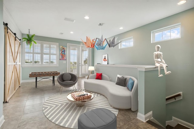 interior space with light tile patterned flooring and a barn door