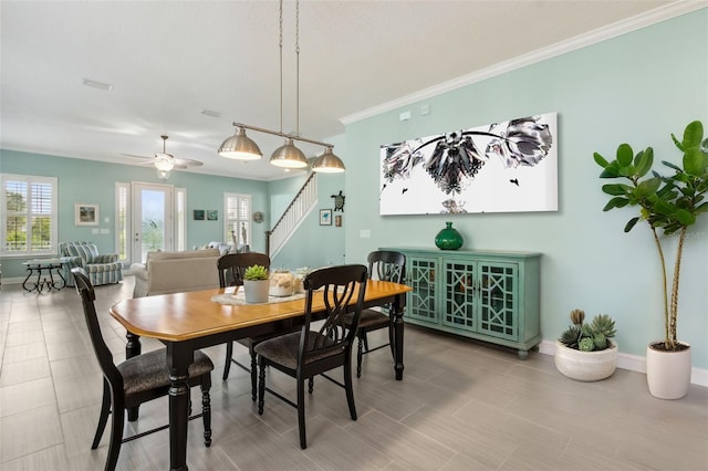 dining room featuring ceiling fan, plenty of natural light, and ornamental molding