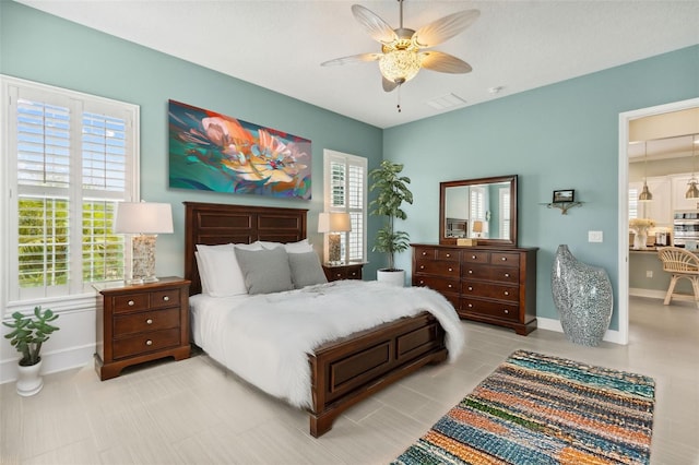 bedroom with ceiling fan and multiple windows