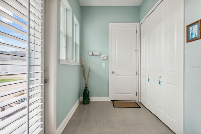 doorway to outside with baseboards