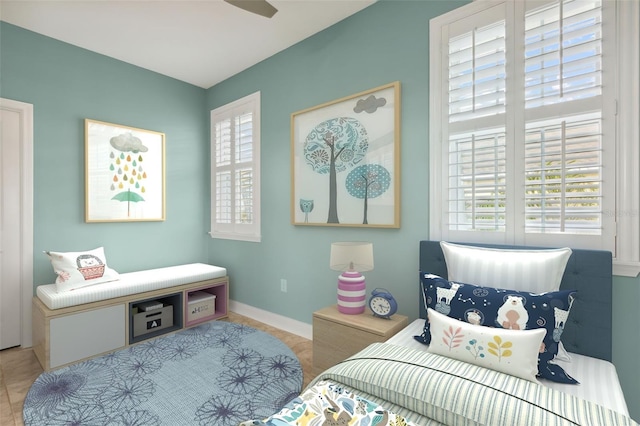 bedroom with tile patterned floors, multiple windows, and baseboards