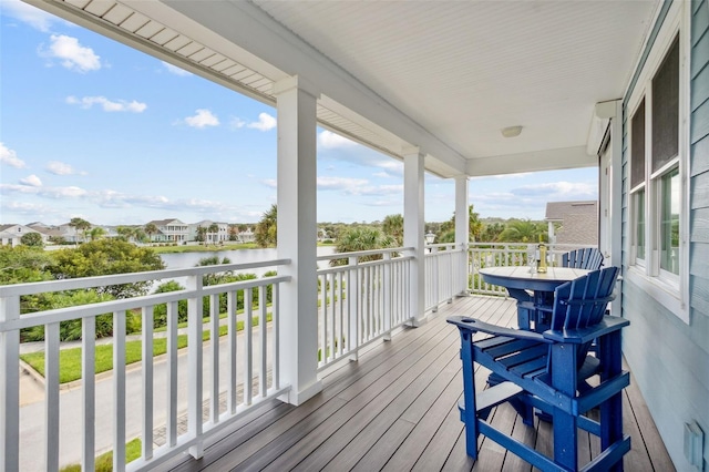 wooden terrace featuring a water view