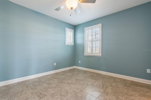 empty room featuring ceiling fan and a textured ceiling