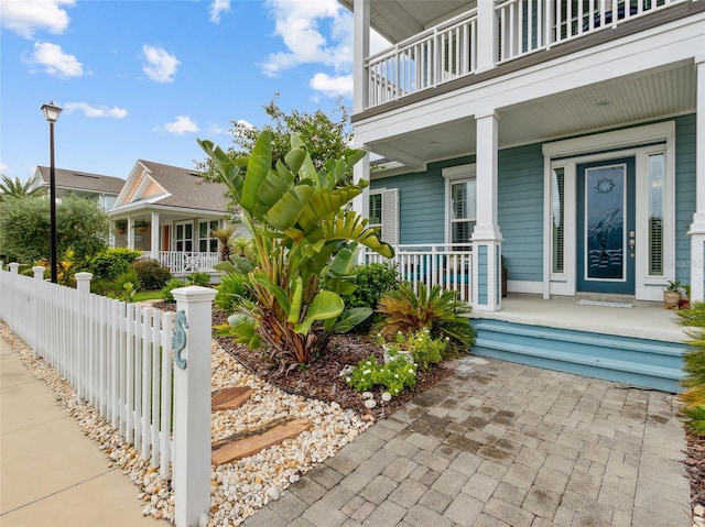 view of home's exterior featuring covered porch and a balcony