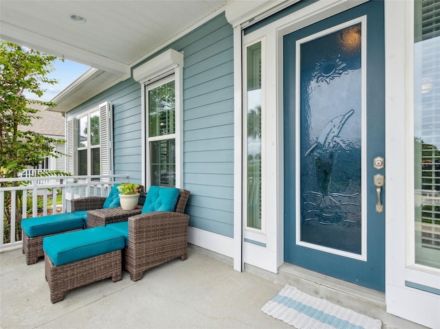 view of exterior entry featuring covered porch