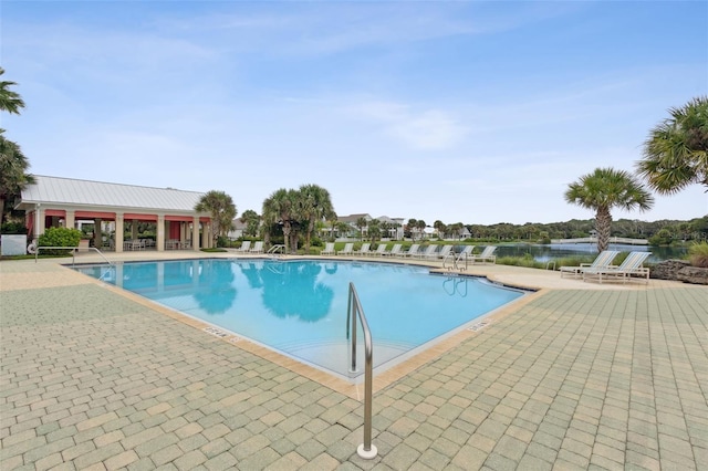 view of swimming pool with a water view, a gazebo, and a patio