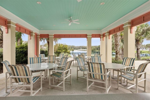 view of patio / terrace with ceiling fan and a water view