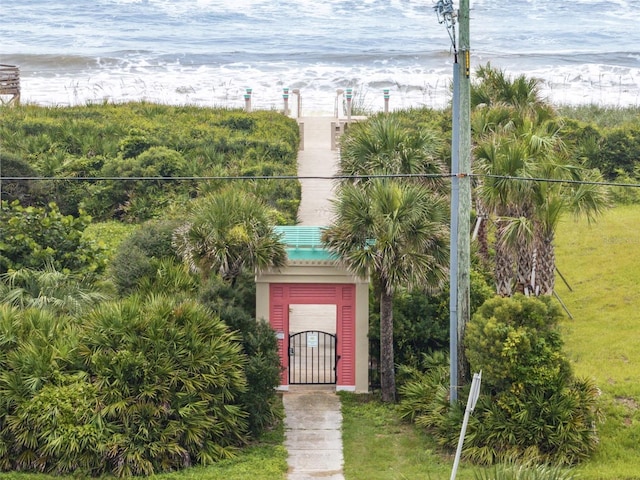 drone / aerial view featuring a beach view and a water view