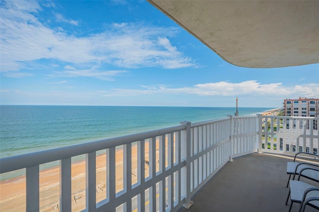 balcony featuring a water view and a view of the beach