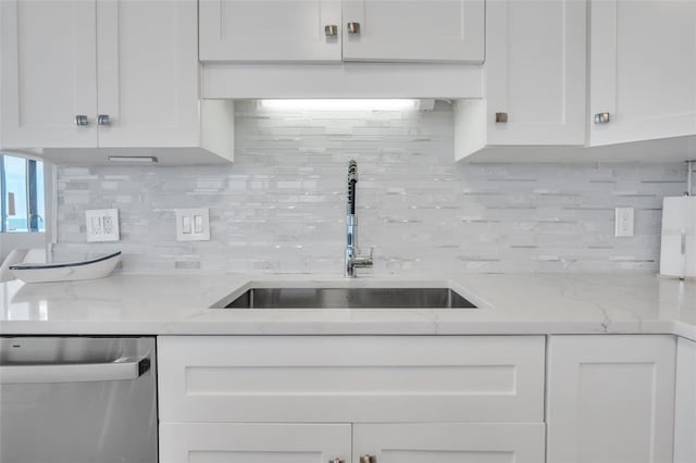 kitchen with dishwasher, sink, and white cabinets