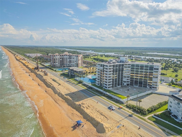 birds eye view of property with a view of the beach and a water view