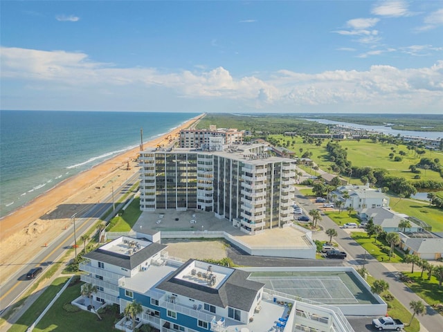 birds eye view of property with a beach view and a water view