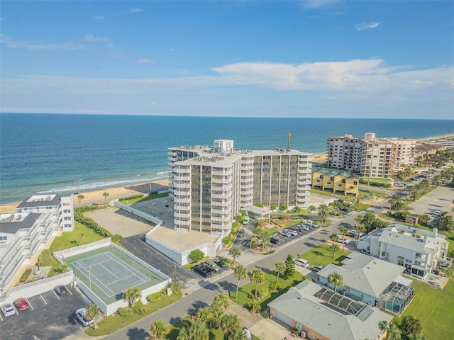 aerial view with a water view and a beach view