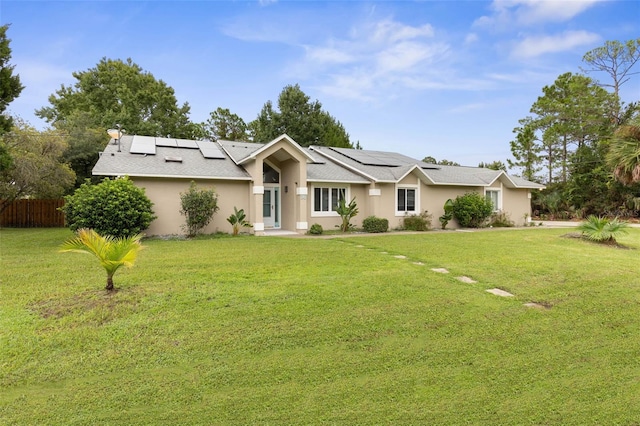 ranch-style house with solar panels and a front yard