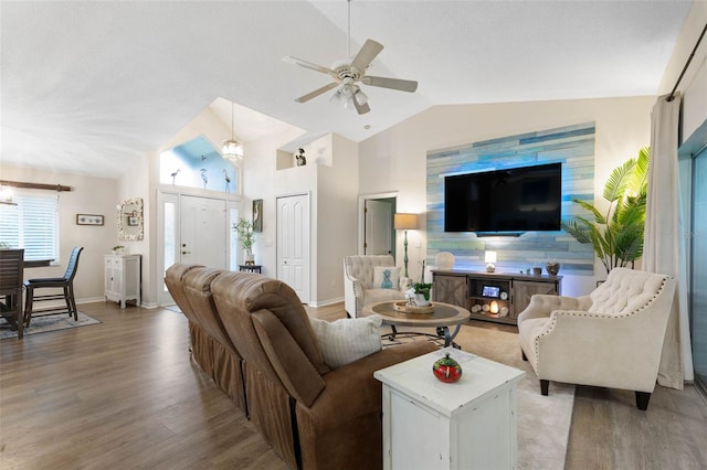 living room featuring lofted ceiling, wood-type flooring, and ceiling fan