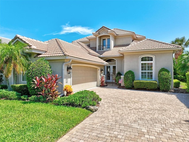 mediterranean / spanish home featuring a front yard