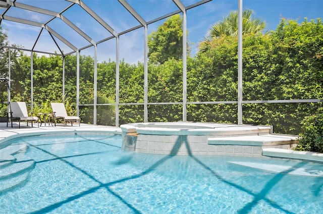 view of pool with glass enclosure and a patio