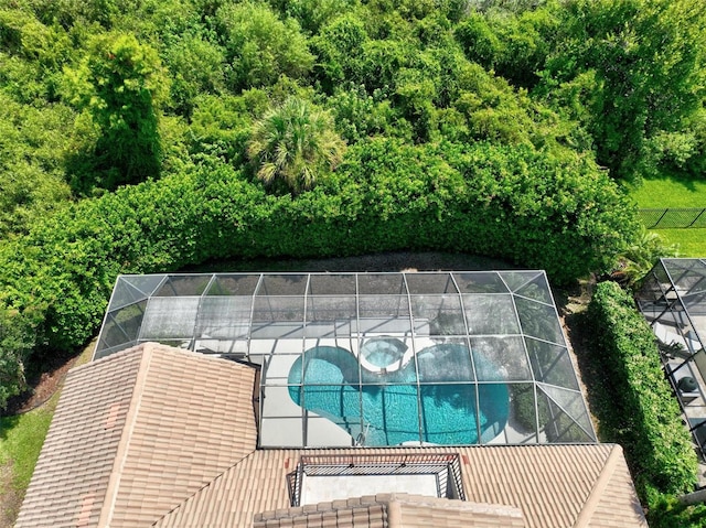 view of pool with glass enclosure and a patio