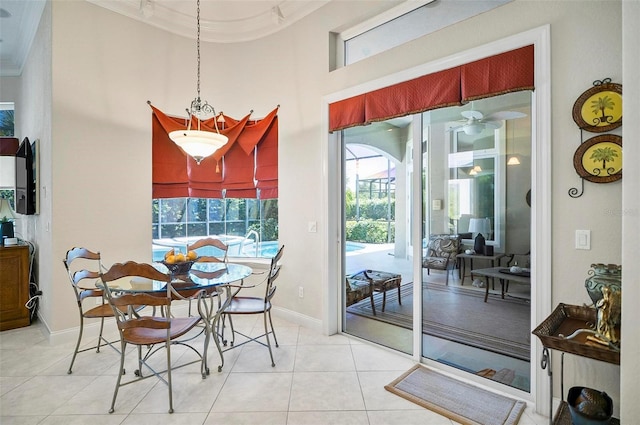 dining area with ceiling fan, light tile patterned floors, and crown molding