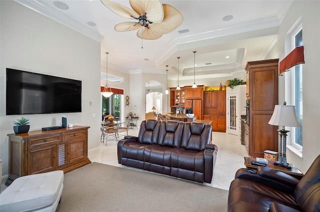 living room with ceiling fan, light tile patterned flooring, and ornamental molding