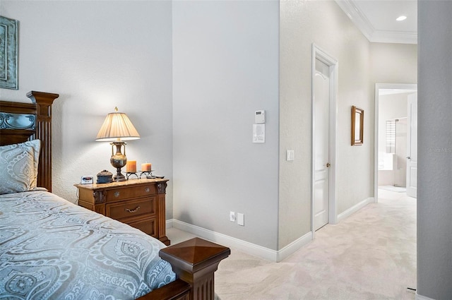 bedroom featuring light colored carpet, ensuite bath, and ornamental molding