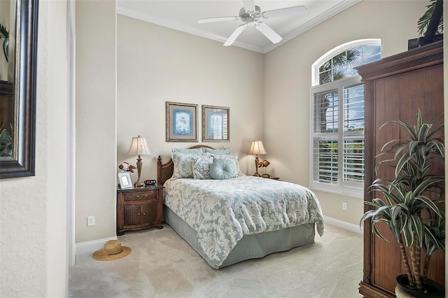 carpeted bedroom featuring crown molding and ceiling fan