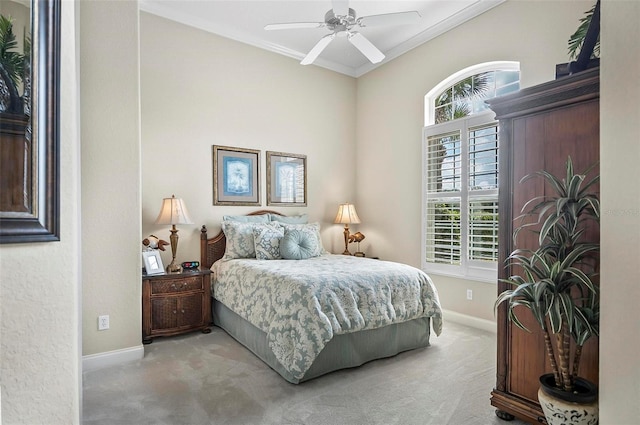 bedroom featuring crown molding, light colored carpet, and ceiling fan