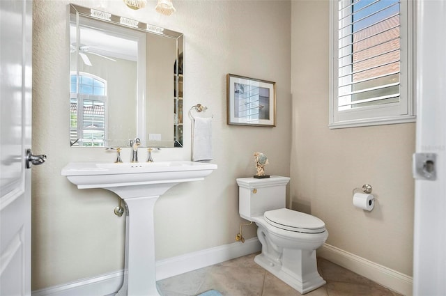 bathroom featuring tile patterned flooring, toilet, and ceiling fan