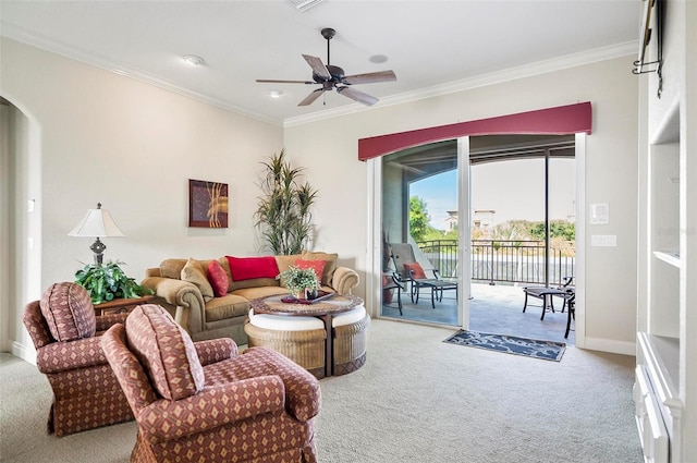 carpeted living room with ornamental molding and ceiling fan