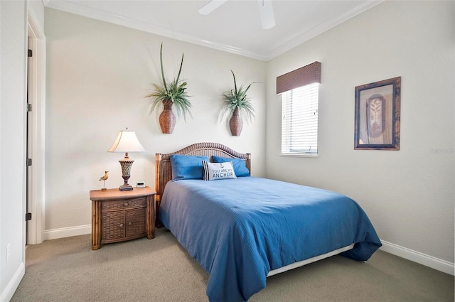 carpeted bedroom with ornamental molding and ceiling fan