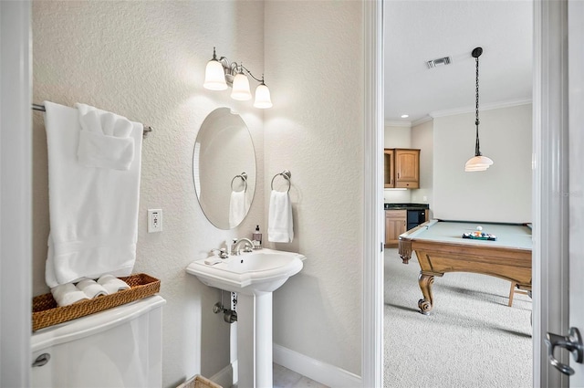 bathroom with crown molding, toilet, and pool table