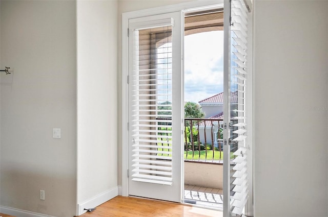 doorway to outside with light wood-type flooring