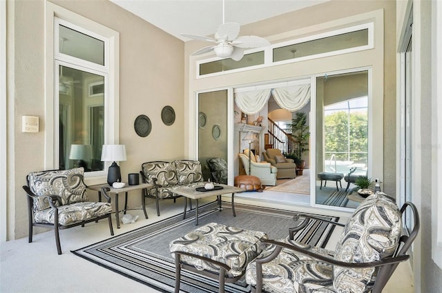 sunroom featuring ceiling fan