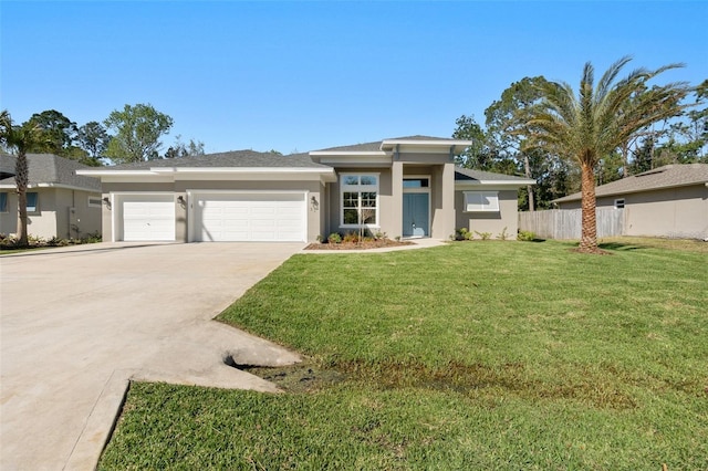 prairie-style house with stucco siding, a front lawn, fence, concrete driveway, and a garage