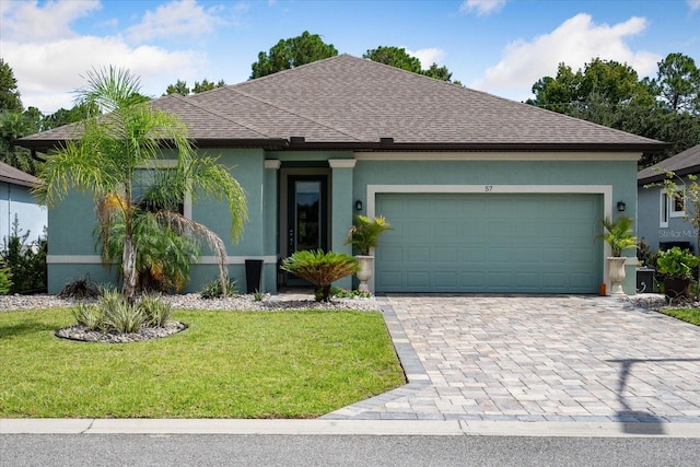 ranch-style home featuring a garage and a front lawn